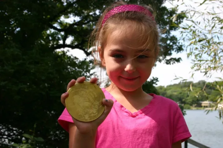 Grace Schueller, 6, of Jordan was so happy her grandpa found the medallion that she ran across the street with him to show her grandma. PHOTO BY MATHIAS BADEN