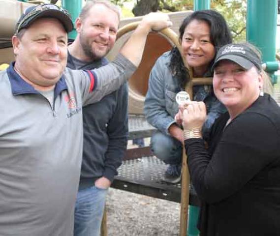 The quartet of (from left) Jeff Miller, Jeff Witt, Angie Johnson, and Ann Miller found the Fall Harvest Medallion beneath playground equipment Friday afternoon (Oct. 13). Johnson found the medallion shortly after the fourth clue was released.
