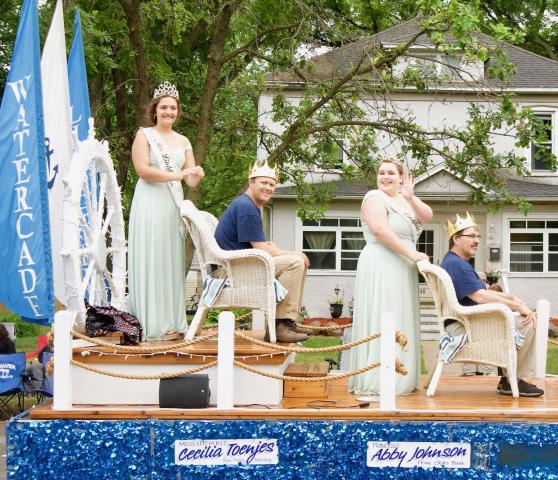 Ceclia Toenjes and Abby Johnson were joined by their fathers on the Watercade float for the Hutchinson Water Carnival parade in June.