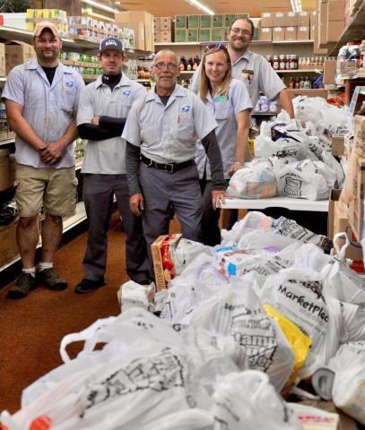 Dean Krug, center, was joined by fellow Litchfield letter carriers Kyle Joramo, Josh Johnson, Becky Magoon and Richard Pennertz as they pose with some of the food they collected during the local group’s stamp Out Hunger food drive in 2019.