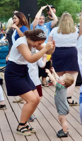 Miss Litchfield Cecilia Toenjes dances with a young fan during the beach party.