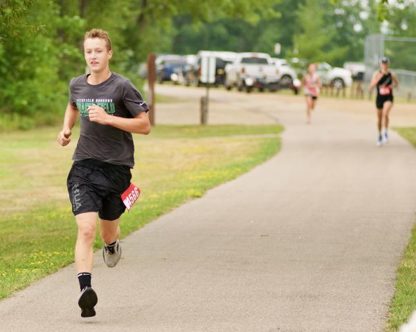 Ole Rogness of Litchfield keeps up a fast pace on the west side of Lake Ripley during the Watercade run Saturday morning. Rogness, 14, finished third overall with a time of 25:20.4. Ryan Adams of Hugo won the race with a time of 23:19, and Maggie Marx of South Haven was the top women’s finisher — and second overall — with a time of 25:04.1.