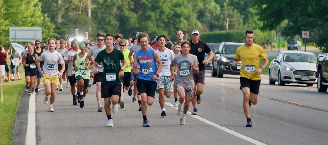 Above — Runners leave the starting line on State Highway 22 Saturday morning for the Watercade's 4-mile run around Lake Ripley.