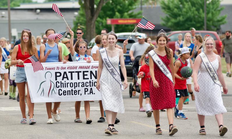 Litchfield royalty, Princess Haylie Magoon, Miss Litchfield Claudia Toenjes, and Princess Abagayle Shoutz, lead the Kiddie Parade participants Saturday morning on Holcombe Avenue.