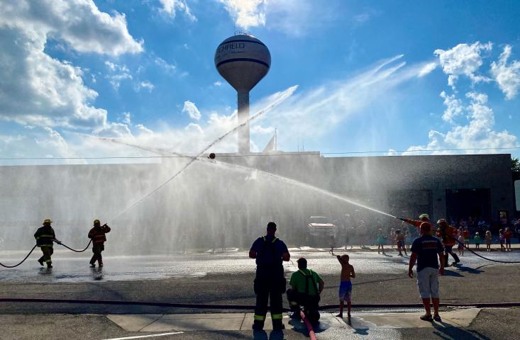 Streams of water criss cross, filling the air with mist during the water ball fight Friday in front of the Litchfield fire and rescue hall.