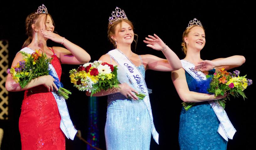 Newly crowned royalty — Princess Abby Stoffer, Miss Litchfield Ayda Granlund and Princess Kylie Guggemos — wave to the crowd at Bernie Aaker Auditorium.