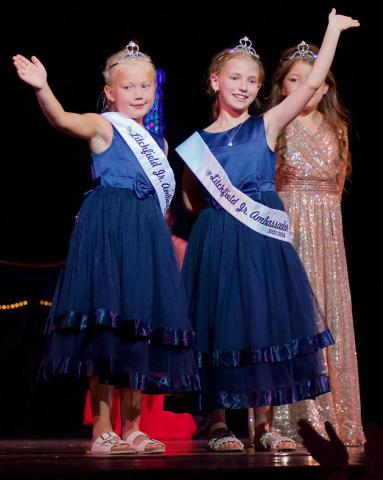 Lexi Bischof and Brynley McGraw, the 2023-2024 Junior Ambassadors, wave to the crowd after being introduced Sunday afternoon. The girls were crowned during a Junior Ambassador coronation Saturday afternoon in Central Park.