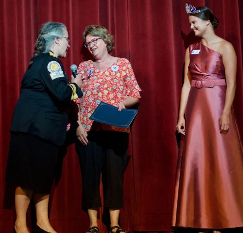 Judy Hulterstrum, middle, receives a certificate and congratulations from Aquatennial Captain Tammy McCanna while Princess Kezia Lee of Cokato looks on. Hulterstrum received the Honorary Commodore Award for her volunteerism and other contributions to the community.