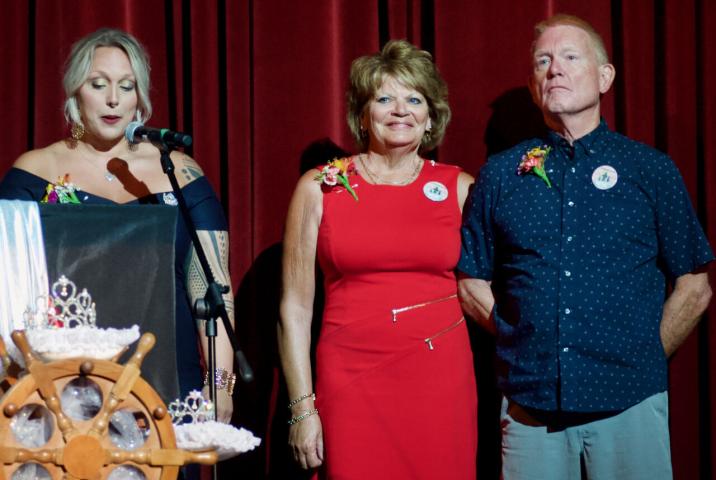 Roxy and Dick Penk had their moment in the spotlight during the Miss Litchfield coronation program at the end of Watercade week in Litchfield. Emcee Ashley Krug, left, read the list of contributions the Penks have made to Litchfield through the years.