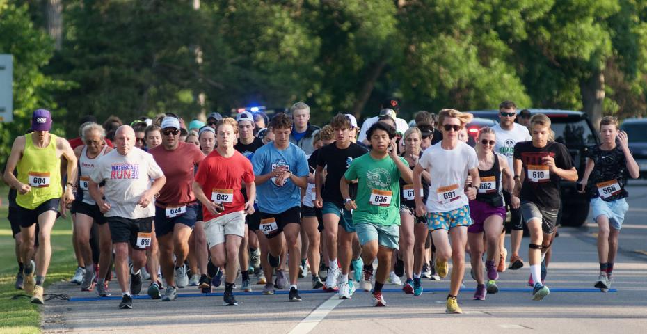 The crowd leaves the starting line at the beginning of the 4-mile run Saturday.