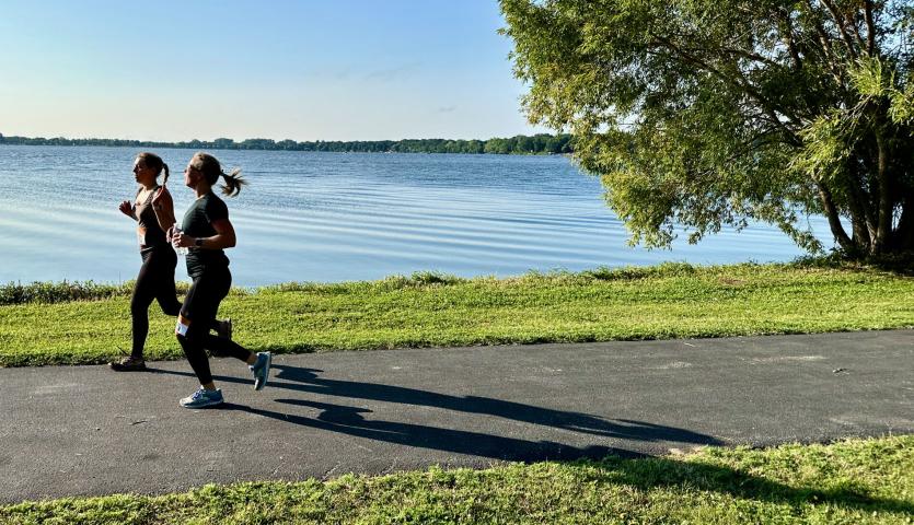 Runners cast a long shadow as they make their way on the path on the west side of Lake Ripley Saturday.