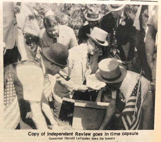 A copy of the Independent Review goes in time capsule. Gov. Harold LeVander does the honors. For just a buck, Litchfield residents could pay to put notes or trinkets into a time capsule to be opened in 2069.  ARCHIVES