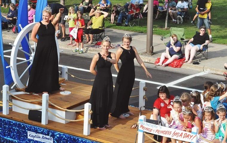 Litchfield royalty from 2012-2013 wave to the crowd gathered at Saturday’s Grand Day Parade. Pictured, from left to right, are Miss Litchfield Kaytlin Bemis, Litchfield Princess Brittany Hull and Litchfield Princess Kaitlyn Johnson. Also pictured is Watercade board member Mary Hansen and children who participated in the Prince and Princess for a Day event.