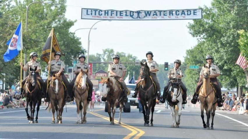 Members of the Meeker County Sheriff’s Office mounted posse ride down the Sibley Avenue during the Grand Day Parade on Saturday.