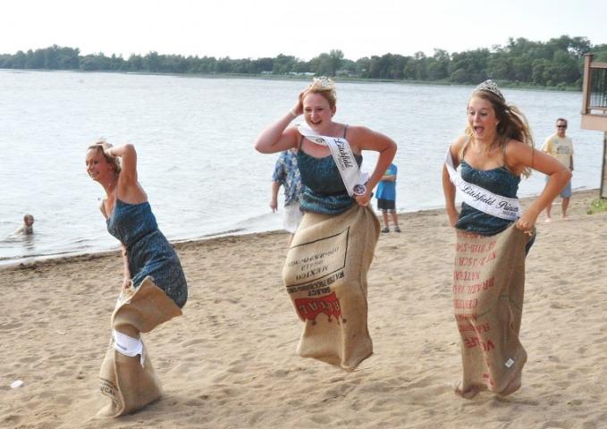 Litchfield royalty from 2012-2013 hop down the beach in potato sacks during the Watercade beach party Friday night. From left to right are Litchfield Princess Brittany Hull, Miss Litchfield Kaytlin Bemis and Litchfield Princess Kaitlyn Johnson.