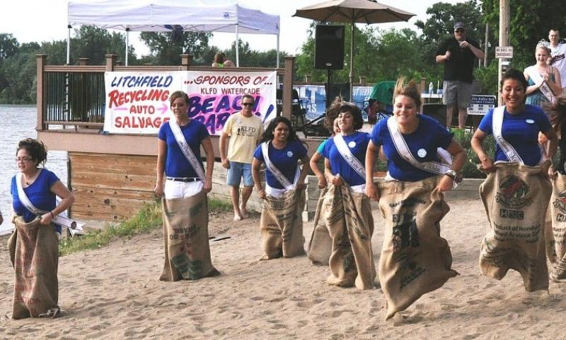The six Miss Litchfield candidates duke it out in a potato sack race during the beach party Friday night. From left to right are Caitlyn Dahl, Paige Dilley, Natasha Gomez, Kate Carlson, Kristen Klaben and Malenny Kranz. Also pictured are KLFD announcers Tim Bergstrom, Randy Quitney and Aaron Imholte, and 2012-2013 Miss Litchfield Kaytlin Bemis.