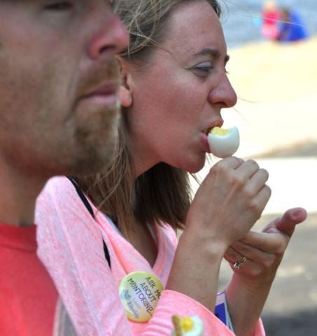 Amy Onell enjoys her egg on a stick, while Andy Twardy already finished his.