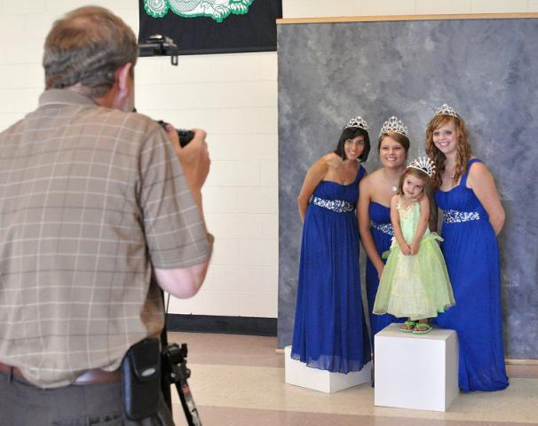 4-year-old Sloan Quinn poses with princess Kate Carlson, Miss Litchfield Kristen Klaben and princess Paige Dilley at the Prince and Princess for a Day event Monday. Cliff Schaefer of Schaefer’s Photography, at left, took pictures of girls and boys with Litchfield royalty.