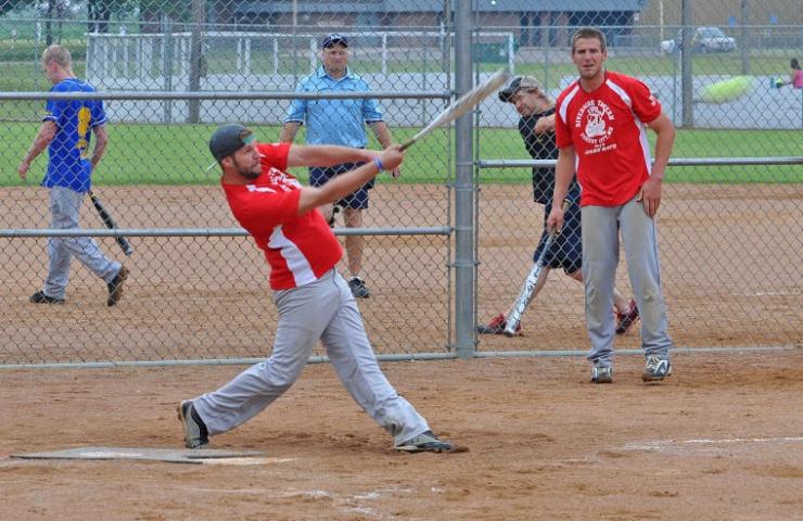 Riverside Tavern’s shortstop Tyler Kielty drives a pitch to left field at the Watecade softball tournament on the morning of July 12. Riverside Tavern lost the morning game to ACC/MKC/HPH, a team from Hutchinson. Riverside Tavern was one of several teams featuring mostly local players.