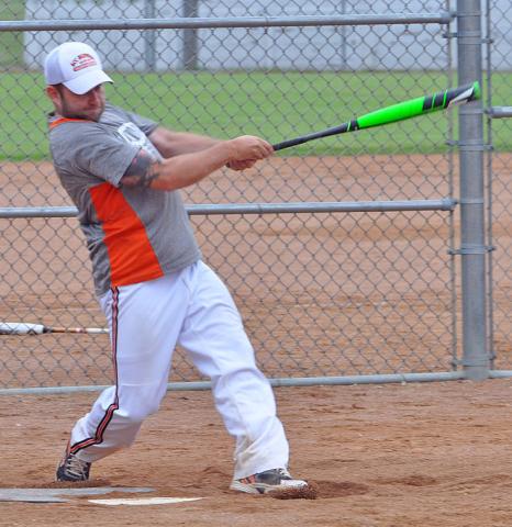 Eric Labraaten, the first baseman for the ACC/MKC/HPH softball team from Hutchinson, follows through after a base hit on July 12 at the Watercade softball tournament.