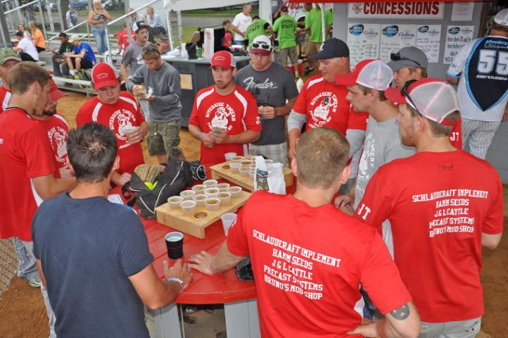 Members of the Riverside Tavern softball team unwind after their first-round loss in the 2014 Watercade Softball tournament, which was sponsored by the Litchfield Fire Department for the third year.