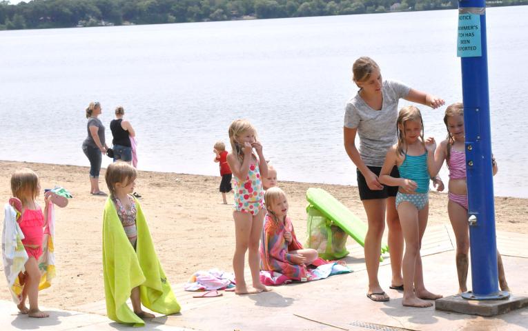 Kids rinse off after swimming in Lake Ripley in Litchfield on July 2. Health officials recommend rinsing and toweling off immediately after swimming to avoid swimmer’s itch.  STAFF PHOTO BY ANDREW BROMAN