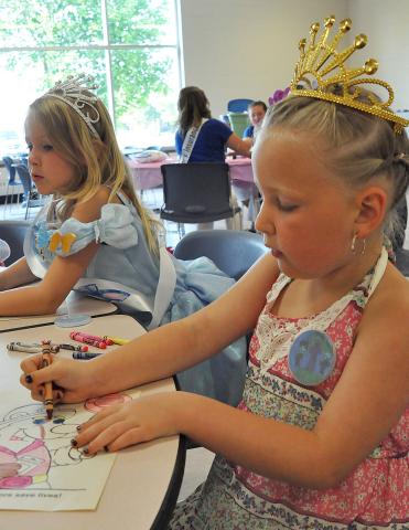 Five-year-old Lucy Ficker colors a picture of a bear. Also pictured, at left, is 5-year-old Elsa Helstrom.