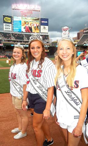 Showing their team spirit, Autumn Raiber, left, Karly Nelson and Kaitlyn Beighley take to the field during Sparkle Night July 30 at Target Field.