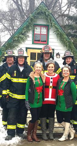 Watercade royalty gathers with Litchfield firefighters, from left, Tom McCormick, Greg Gilbertson, Glendon Caron and Jason Brown, at Santa’s house in Central Park on Dec. 5.