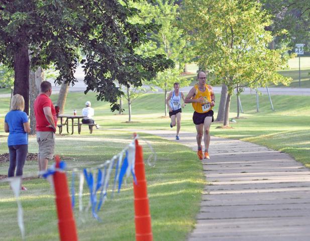 Tracy Sik (132), 45, of Willmar, Tom Ost (102), 56, of Willmar, and Maximilian Anderson (156), 11, of Coeur d'Alene, Idaho stride toward the finish line of Saturday's Watercade Lake Ripley Run. Sik, Ost and Anderson finished 15th, 13th and 14th, respectively, in the four-mile race.