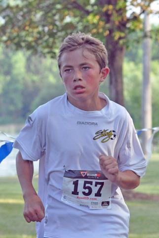 Klinton Van Heuveln (143), 22, and Samantha Van Heuveln (144), 21, of Kerkhoven, race toward the finish line at Saturday's four-mile Watercade run. Samantha and Klinton both finished the race in 27 minutes and nine seconds, and Samantha Van Heuveln was the top female finisher.