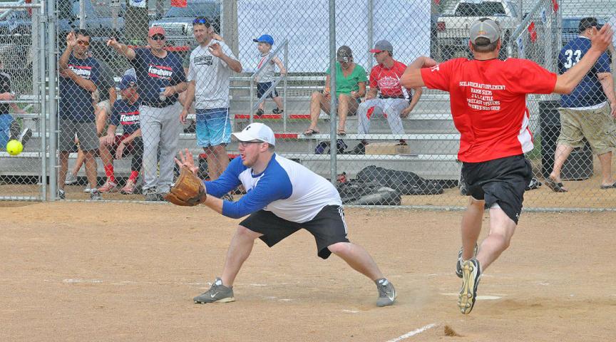 Charlie Hamm, right, of Litchfield, scores a run for Riverside Tavern as FM Janitors’ catcher Marcus Buschette, left, of Moorhead, fields the late throw during Saturday’s Litchfield Fire Department Softball Tournament.