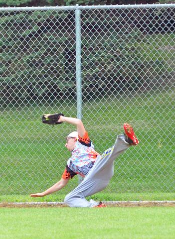 Hilltop Broadshop right fielder Dillon Storm, of Litchfield, makes a falling catch in right field during the Litchfield Fire Department’s slow pitch softball tournament Saturday. Hilltop Broadshop lost all three of its games in the 28-team men’s tournament.