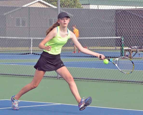 Taylar Smith, of Litchfield, lunges for a left-handed forehand during the Watercade mixed doubles tournament Saturday. Smith and her grandfather, Jack Litzan, of Litchfield, won their tournament-opening match before being eliminated 0-6, 1-6 by Joe Meier, of Hutchinson, and Colleen McCollaugh, of Maple Grove.