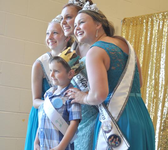 Prince Dylan Smith poses for a photo with Watercade Princess Kaitlynn Beighley, Miss Litchfield Karly Nelson and Watercade Princess Autumn Raiber.