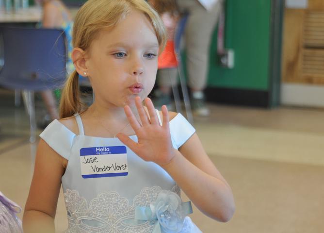 Josie VanderVost blows on her freshly painted nails at last week's Prince and Princess for a Day celebration.