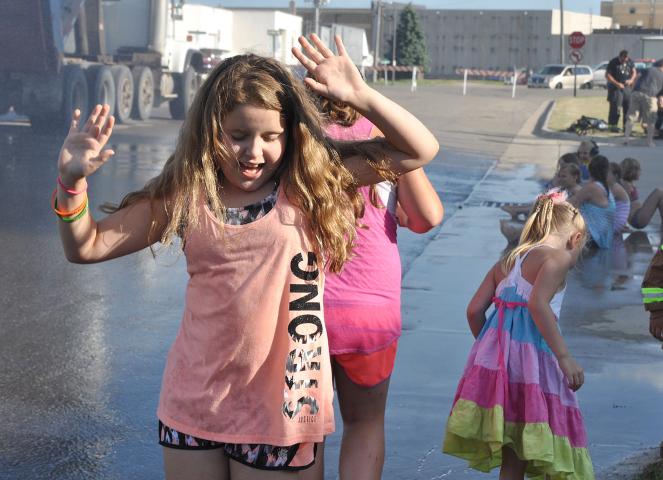 Kids danced in the rain at last year’s Watercade Grand Day Parade.