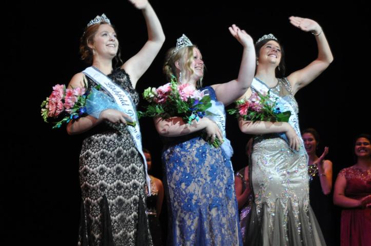 Princess Michelle Oster, Miss Litchfield Hailey Stoffer and Princess Justine Madsen wave to the crowd for the first time after being crowded as this year's Watercade royalty.   STAFF PHOTO BY MARTHA LUEDERS
