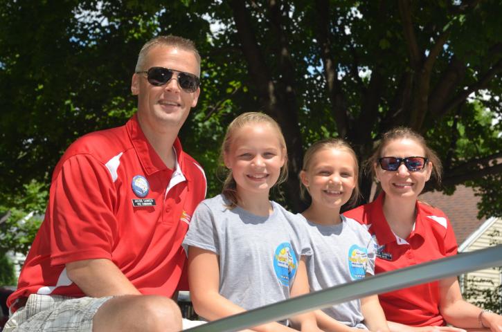 The Jacob Sanken family were all smiles as they greeted the public during Sunday's Grande Day Parade. The family will represent Hutchinson at many area parades in the coming months.  Staff photo by Doug Johnson