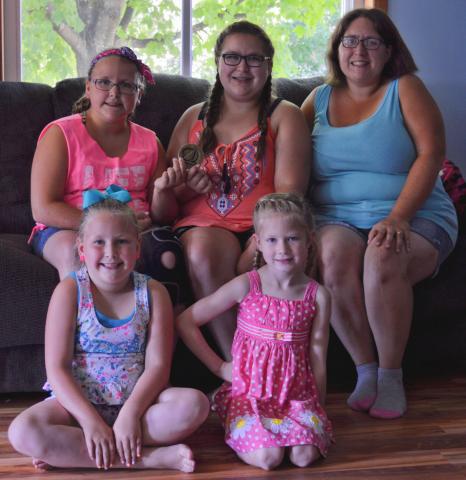 From left, Chelsea, 11, Cali, 14, Lori, Lucy, 7, and Tattrie Ficker, 5, found the Watercade medallion at Thompson Park July 3.  Photo by Samuel Carlson