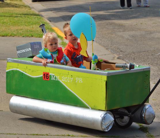 Siblings Jackson, 1, and Liam Putzke, 4, cruised in their green pontoon at the Kiddie Parade July 8.