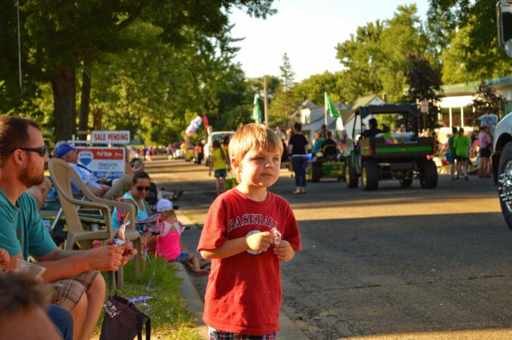 Odin Larson, 4, watched as the Haug Implement float passed by in the Grand Day Parade Saturday.