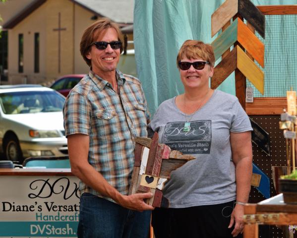 Artists Chris and Diane Leonard, (Diane’s Versatile Stash) showed off one of their barn-wood crafts at Art in the Park Saturday afternoon.
