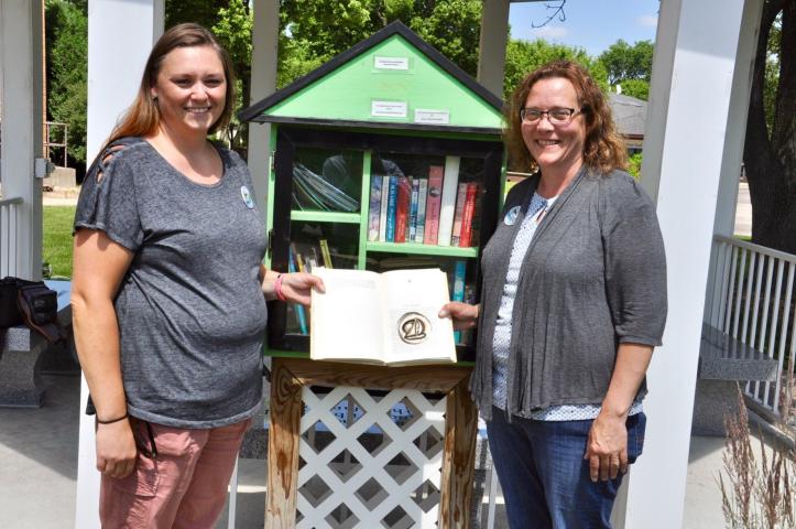 Erica Carlson and Heid Johnson found the Watercade medallion inside a book in the Little Free Library at Meeker Memorial Hospital.