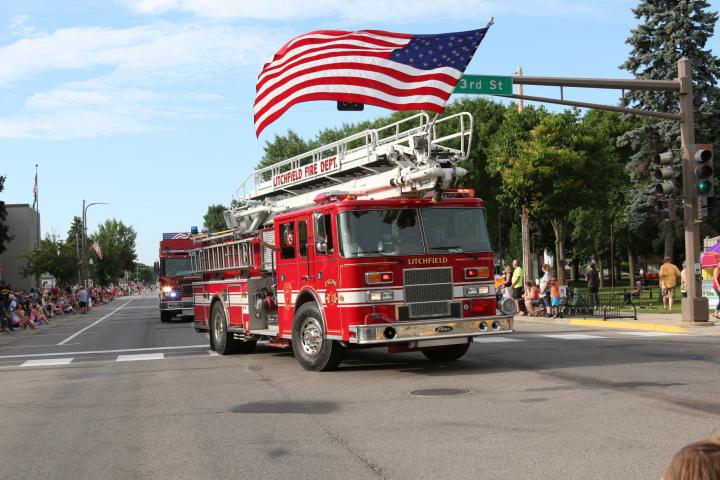 Litchfield Fire Department dons a large American Flag on one of its engines during the Watercade Parade.
