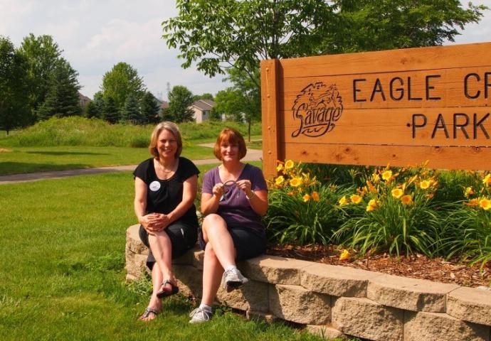 The Dan Patch Days horseshoe clues led Jane Broberg (left) and Jane Kappes to Eagle Creek Park where the horseshoe was found in the evergreen trees pictured in the distance.  SUBMITTED PHOTO