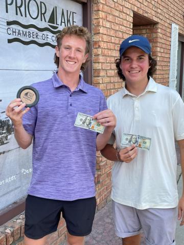 Kyle Nordling, left, and Kendall Stewart, right, stand with the medallion they found and their $200 prize during the Ekim Orthodontics Medallion Hunt presented by the Prior Lake Chamber Fest.  Submitted photo