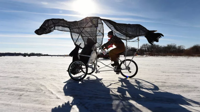 Clara Schiller pedals visitors in her Seal Pedicab out to the structures in the Art Shanty Project on White Bear Lake, Sunday, Feb. 5, 2017. (Pioneer Press: Scott Takushi)