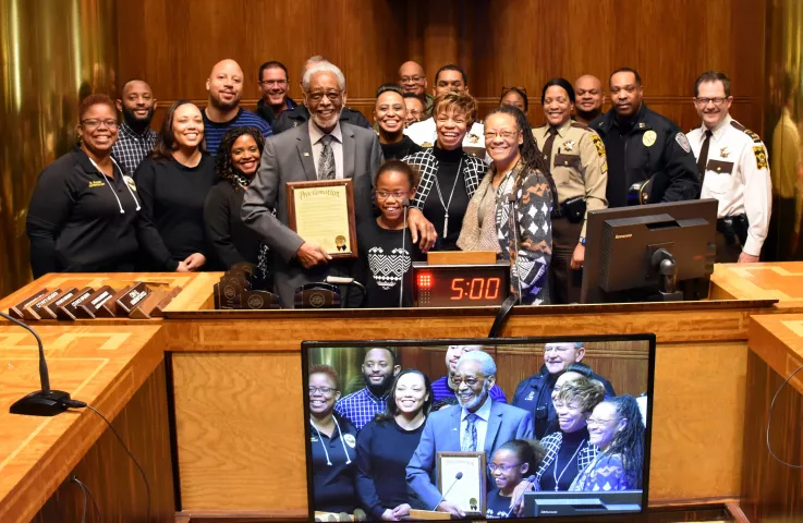 Art Blakey Jr. gathers with his family — including his 9-year-old granddaughter, Braylyne Blakey, whom he has his arm around, and wife, Carolyn Carroll-Blakey — after Ramsey County Commissioner Toni Carter presented him with a proclamation for his years of law enforcement service at the county board meeting in St. Paul on Tuesday, April 3, 2018. Blakey formerly worked for the Ramsey County sheriff’s office and members of the department, including Sheriff Jack Serier, are at right. (Mara H. Gottfried / Pione
