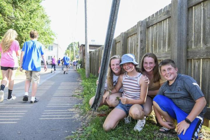 The Bar-B-Q Days coin has been found by Rachel Johnson (second from left), 12, in the alleyway behind the Belle Plaine Post Office. To Rachel's left is her sister Elizabeth Johnson and to her right are Cameron and Carter Chard.  Rachel was confused at first when she stumbled across a wad of black duct tape, but further investigation led to the coin's discovery. Casey Ek